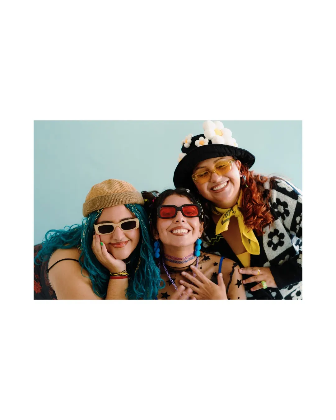 Three women smiling together, representing community and shared experience