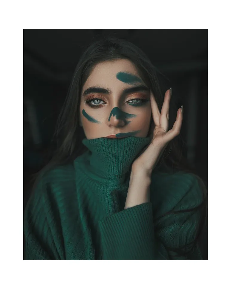 A woman with green paint on her hands, symbolizing the messy reality of healing